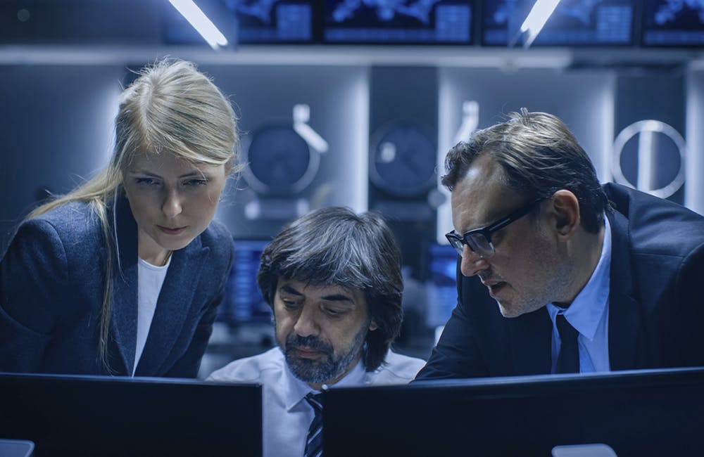 Male and Female Operators Working On Computers in System Control Room. Secret Government Agency Analysts Doing Research, Conducting Cyber Security Investigation.