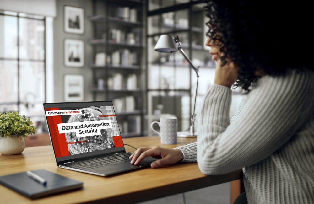 woman sits at computer in modern home office