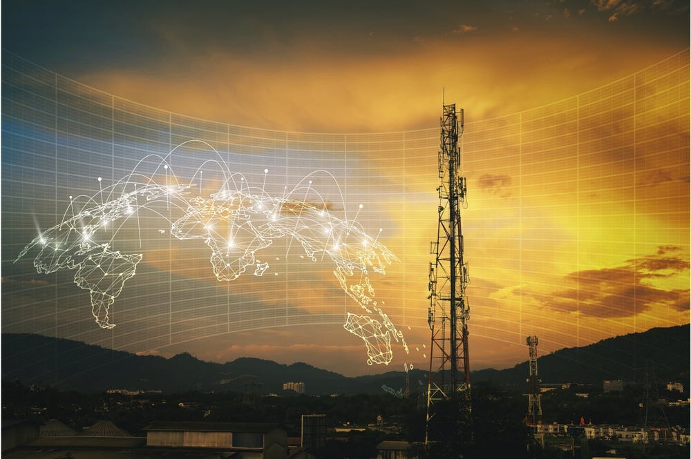 Telecommunication tower during sunset with HUD graphical internet worldwide connectivity of 3G, 4G and 5G network. Technology concept. Antenna, microwave, repeater, base station. Mobile communications