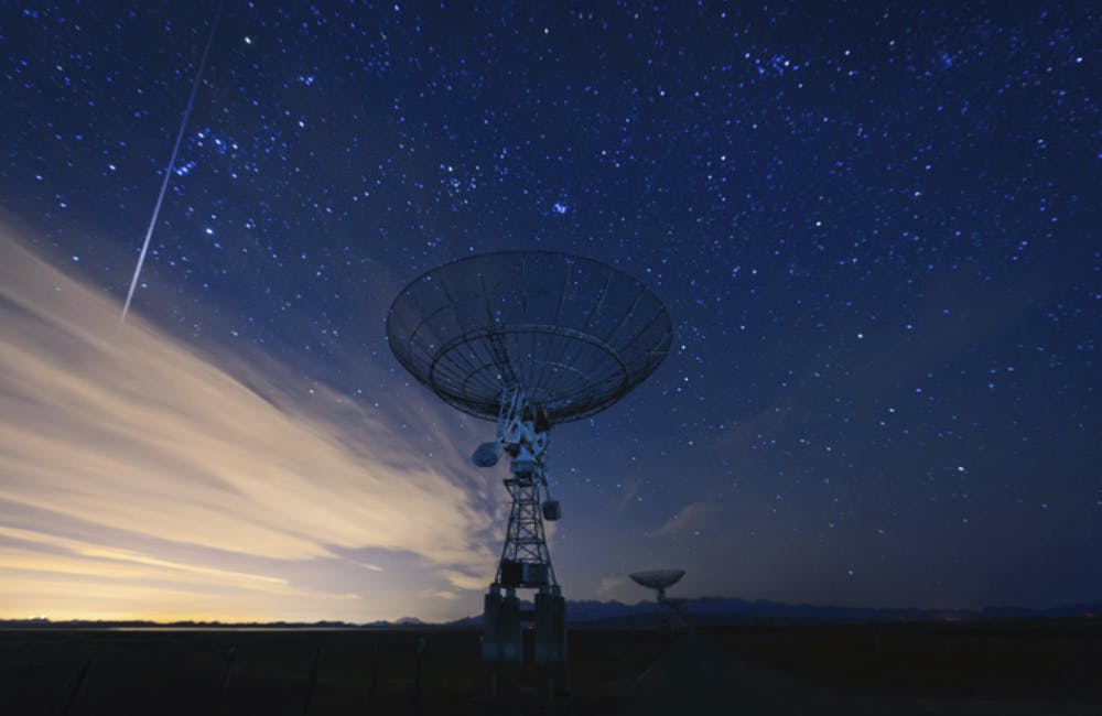 satellite dish under a starry sky