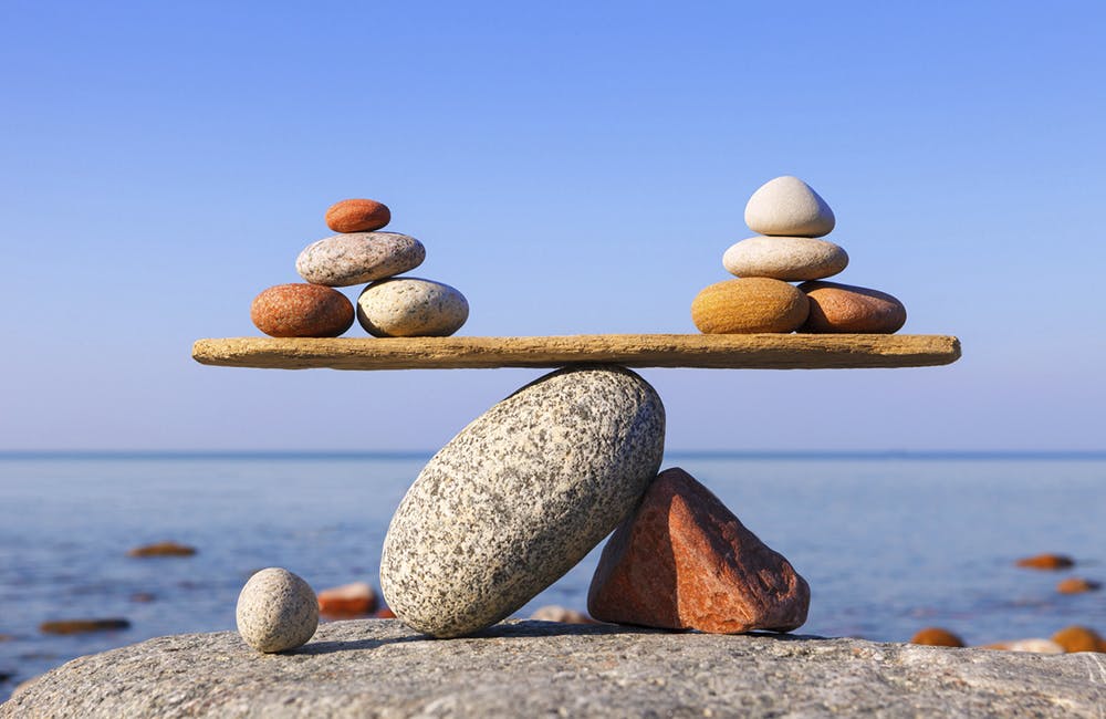 Symbolic scale of the stones on sea background. Concept of harmony and balance. work-life, emotional balance (Symbolic scale of the stones on sea background.