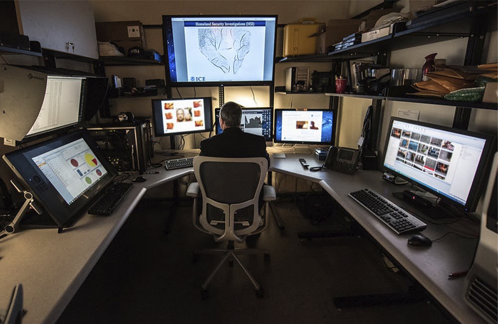 An ICE Cyber Crimes specialist works in a room that is setup to help identify child abusers and their victims.