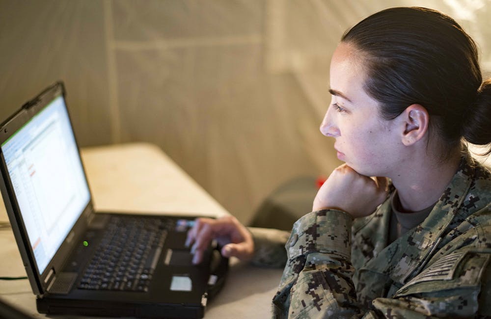 Information Systems Technician 2nd Class Tiffany Adams, assigned to Naval Construction Group 2, maintains a computer network.
