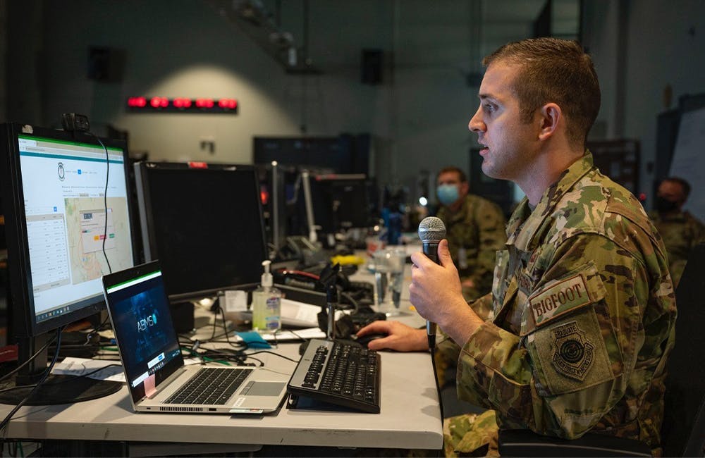 An airman from the 225th Air Defense Squadron briefs staff on the capabilities of the DevSecOps-enabled Advanced Battle Management System at Nellis Air Force Base’s Shadow Operations Center.