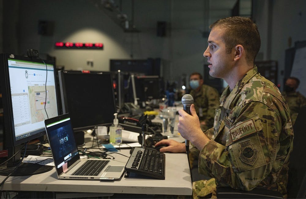 An airman from the 225th Air Defense Squadron briefs staff on the capabilities of the DevSecOps-enabled Advanced Battle Management System at Nellis Air Force Base’s Shadow Operations Center.
