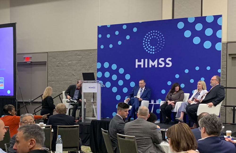 Defense Health Agency's Pat Flanders, VA's Terry Adirim, DHMS' Holly Joers and FEHRM's Bill Tinston speak at the HIMSS conference in Orlando, Florida.
