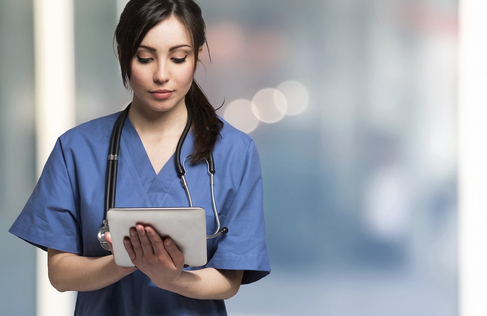 Portrait of a nurse using a digital tablet.