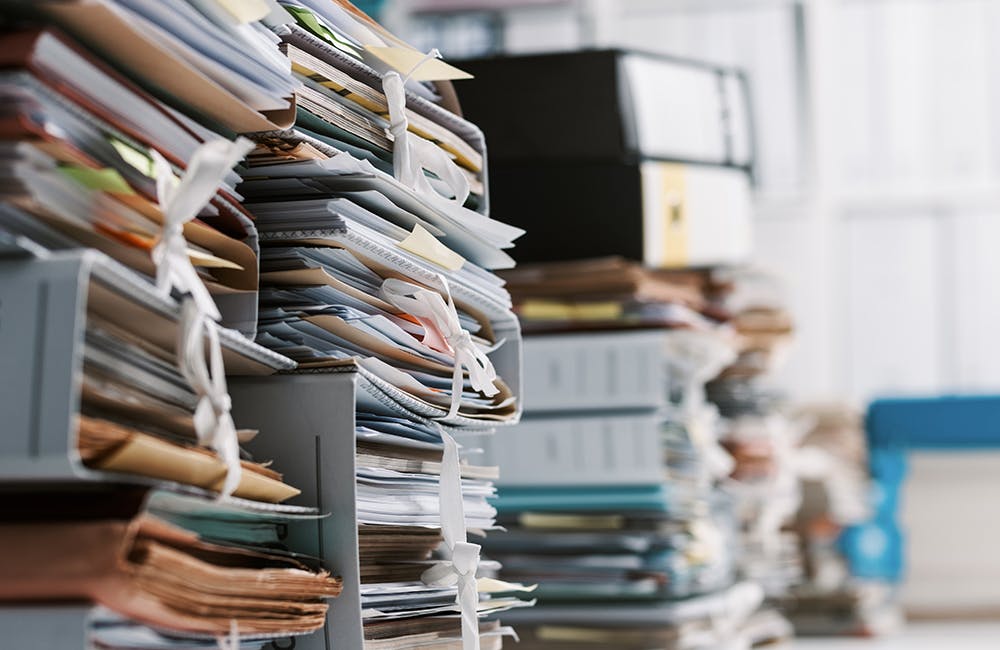 image of stacks of paperwork and files in the office