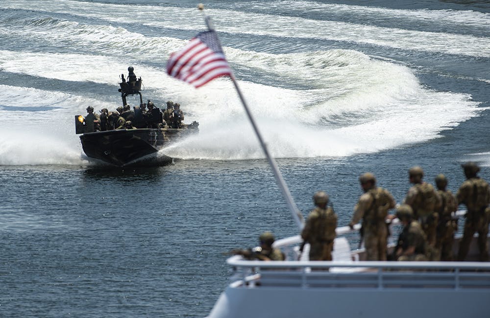 image of U.S. Special Operations Command and international service members decend on the City of Tampa, Florida, in a vessel during a Special Operations Forces capabilities demonstration May 18, 2022.