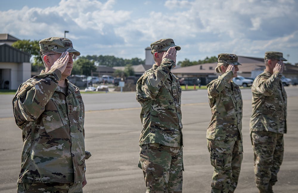 image of From left to right, U.S. Air Force Lt. Gen. Jim Slife, commander of Air Force Special Operations Command, U.S. Air Force Chief Master Sgt. Cory Olson, command chief of AFSOC, U.S. Air Force Col. Jocelyn Schermerhorn, commander of the 1st Special Operations Wing, and U.S. Air Force Chief Master Sgt. Bill Adams, command chief of the 1st SOW, render a salute at Hurlburt Field, Florida, June 17, 2020.