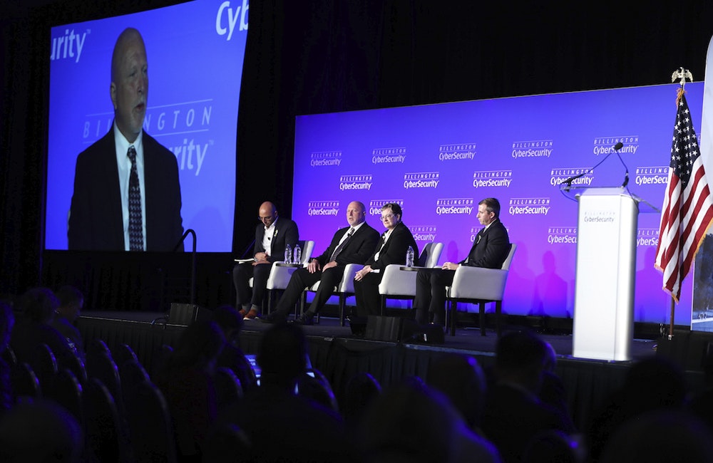 image of DOD Deputy CIO for Cybersecurity David McKeown speaks with panelists including Federal CISO Chris DeRusha at Billington Cybersecurity Summit in Washington, DC, September 7, 2022