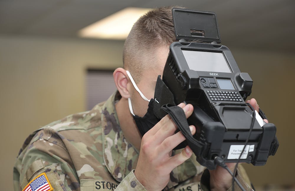 image of Pfc. Brady Stobbe from the 603rd Military Police Company based in Belton, Missouri, scans his iris on a Biometrics Automated Toolset Army Kit during Operation Ready Warrior (ORW) 20-1 at Fort Hunter Liggett, California September 15, 2020.