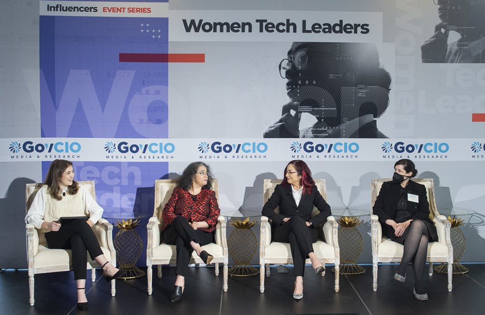 image of Veterans Affairs' Laura Prietula, FEMA's Monica Langley and Equal Employment Opportunity Commission's Liza Zamd speak on a panel during the July 14, 2022 Women Tech Leaders event in Washington, DC.