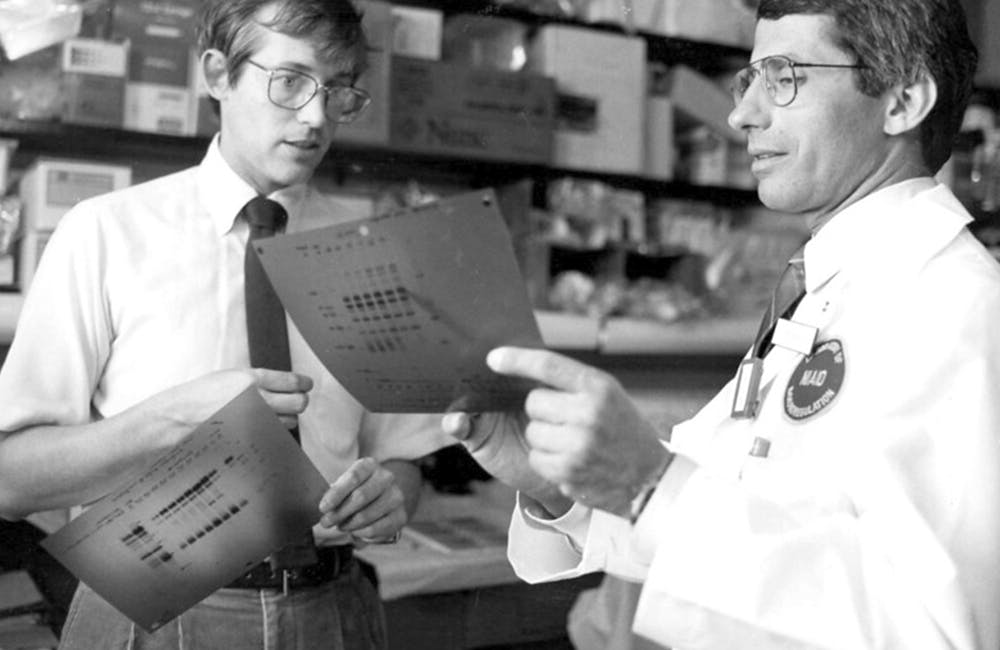 image of Doctors Anthony Fauci and Clifford Lane discussing AIDS-related data in 1987.