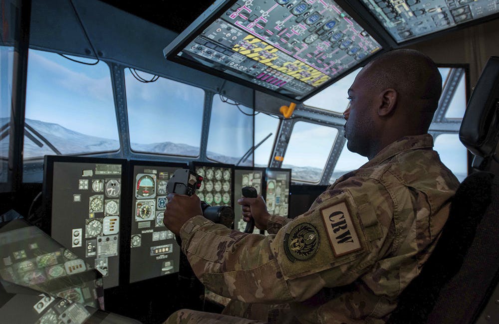 image of A participant in the Data Link User Group conference pilots a C-130 Hercules aircraft flight simulator at Rosecrans Air National Guard Base, Mo., on Aug. 3, 2018