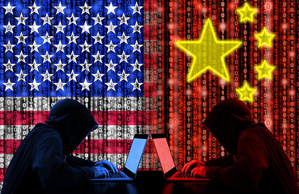 conceptual cybersecurity image showing American hacker sitting opposite of a chinese hacker cyberwar concept in front of binary flags intended to represent how Chinese cyberattacks, cyber crime remain top threats for FBI Director