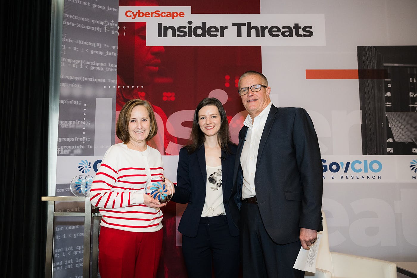 Stacy Bostjanick, DOD, accepting a Flywheel Award for Cyber Defender