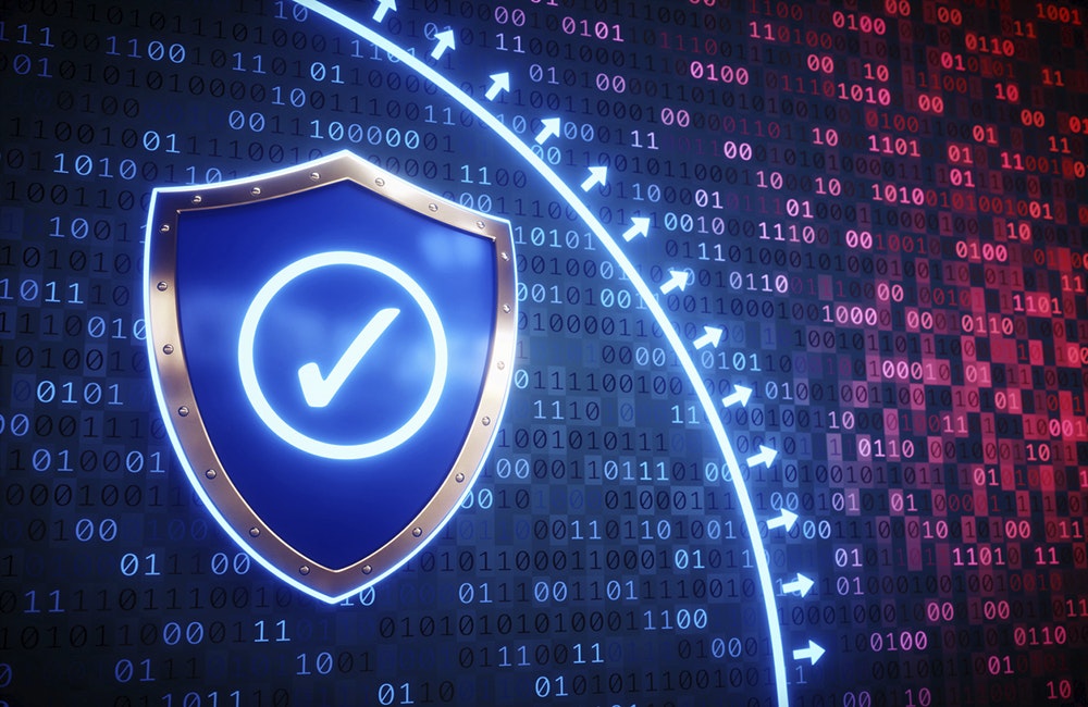 An abstract concept of a digital firewall. A surface of glowing binary code is divided into two parts by a separation line with arrows: a safe blue part and an infected red part. There is a symbolic shield with an OK checkmark lying on the blue part.