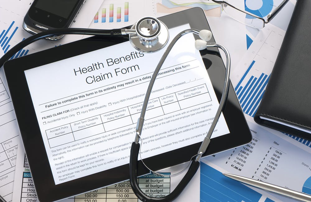 Online health benefits claim form with stethoscope