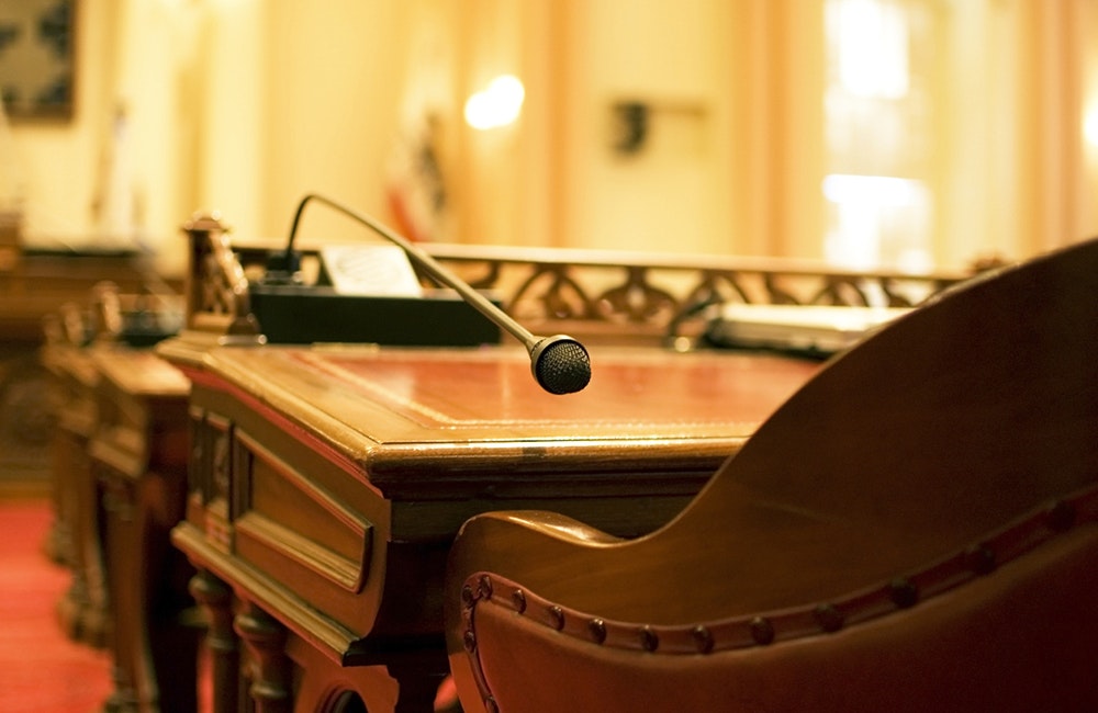 A microphone on the antique desk of a California State Senator. In the chambers of the California Senate in Sacramento.