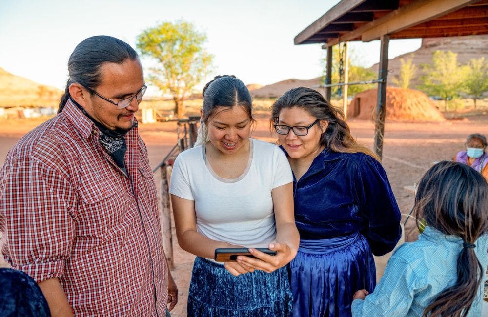Navajo Family Spending Time Sharing Photos from a Smart Phone