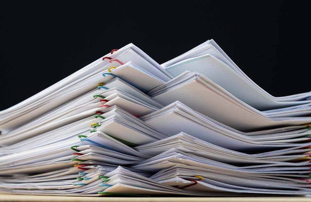 Image of stacks of paper on desks