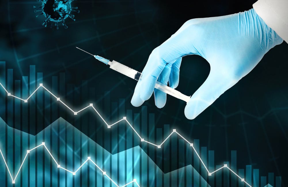 Reducing the number of infected covid-19. Stabilization of the global situation with pandemic. Coronavirus vaccine concept. Close-up hand in blue glove holding syringe on graph down background