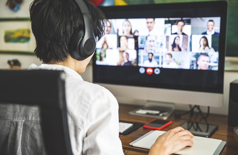 Woman working at home having a video conference with colleagues