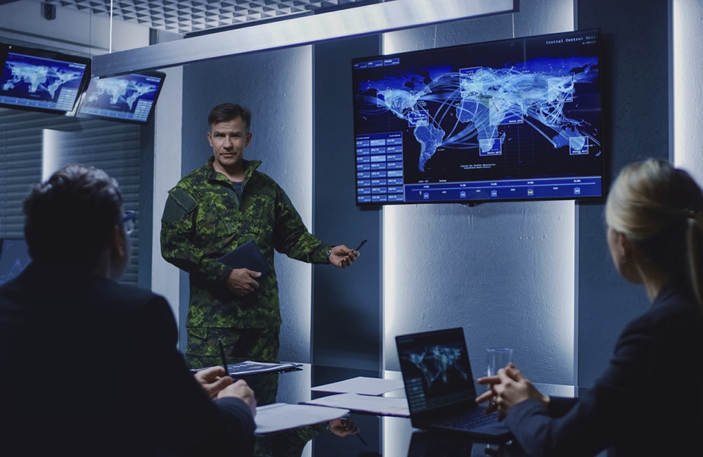 High-Ranking Military Man holds a Briefing to a Team of Government Agents and Politicians, Shows Satellite Surveillance Footage.