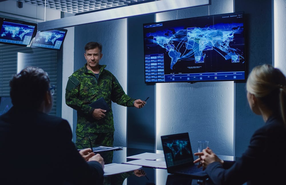 High-Ranking Military Man holds a Briefing to a Team of Government Agents and Politicians, Shows Satellite Surveillance Footage.