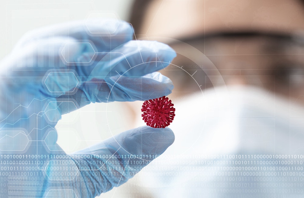 woman scientist holding a coronavirus in a research lab