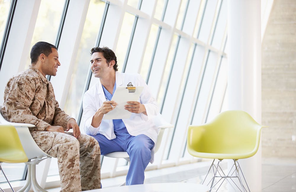 Doctor Counselling Soldier Suffering From Stress Having A Discussion