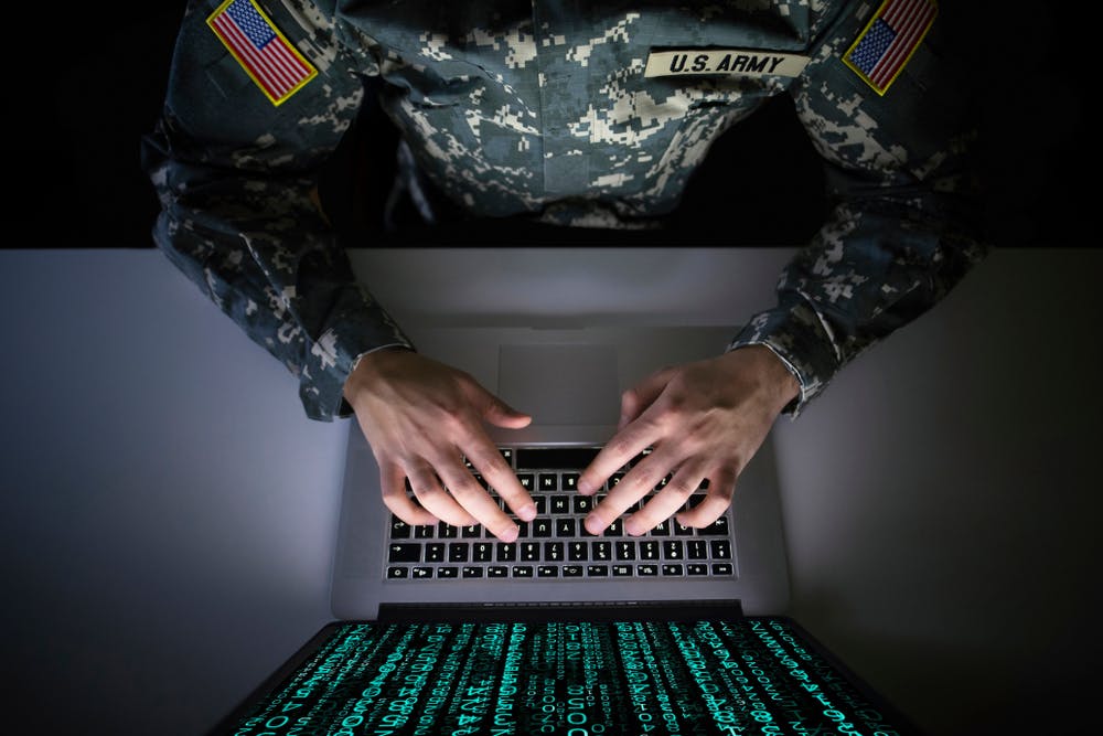 army soldier typing on a computer