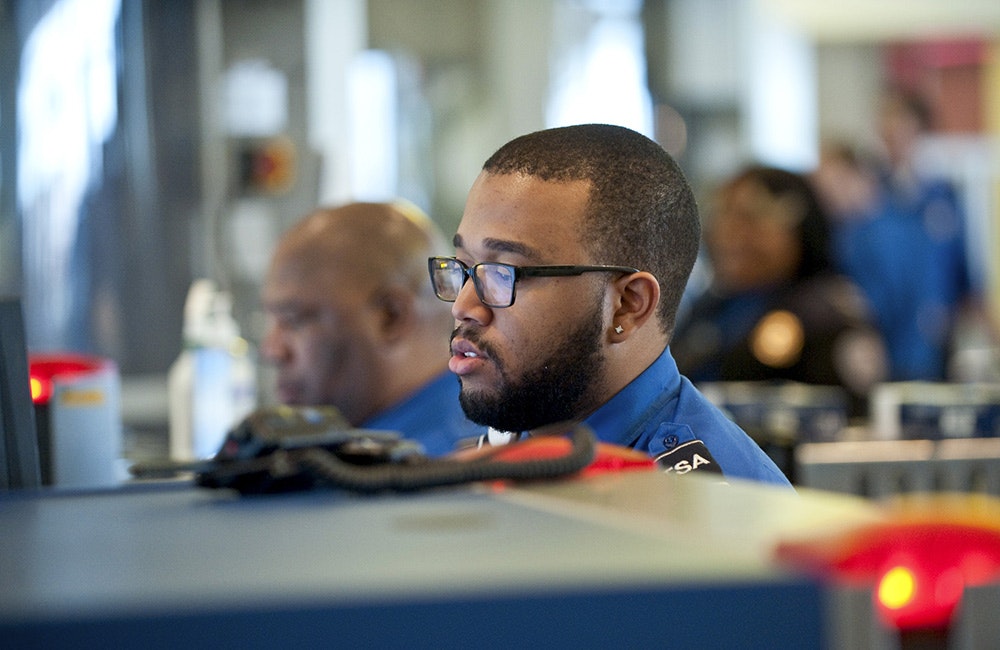 A TSA agent monitors the x-ray machine in the security line at BWI airport