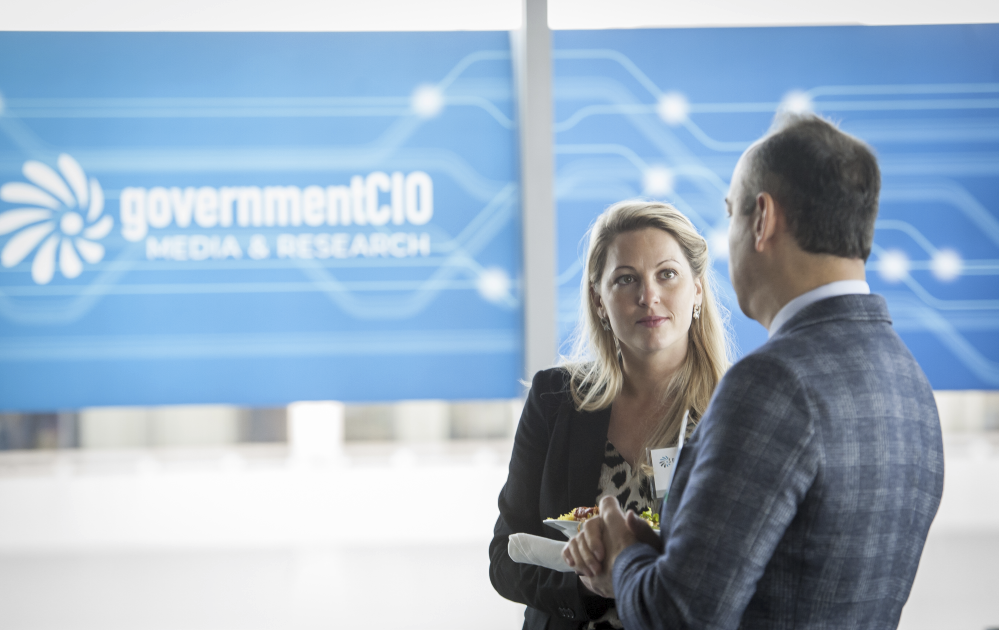 Pegasystems's Debbie Vera speaks with a fellow attendee during the networking break at the AI & RPA CXO Tech Forum. (Rod Lamkey Jr./GovernmentCIO Media & Research)