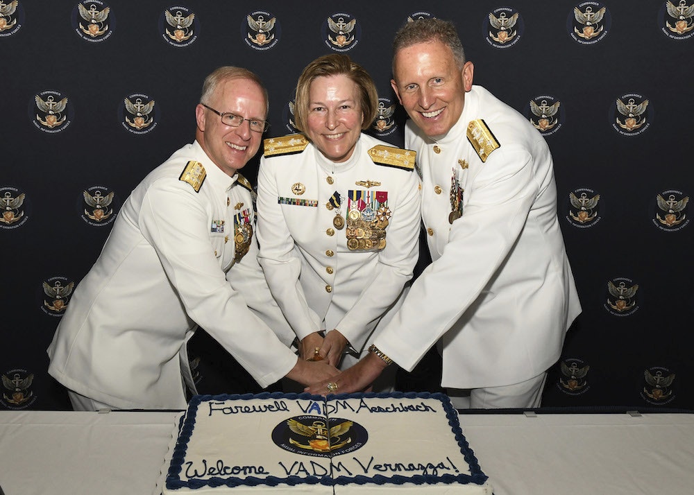 Adm. Daryl Caudle, Commander, Vice Adm. Kelly Aeschbach, and Vice Adm. Mike Vernazza participate in a cake-cutting ceremony during a change of command ceremony on July 26.