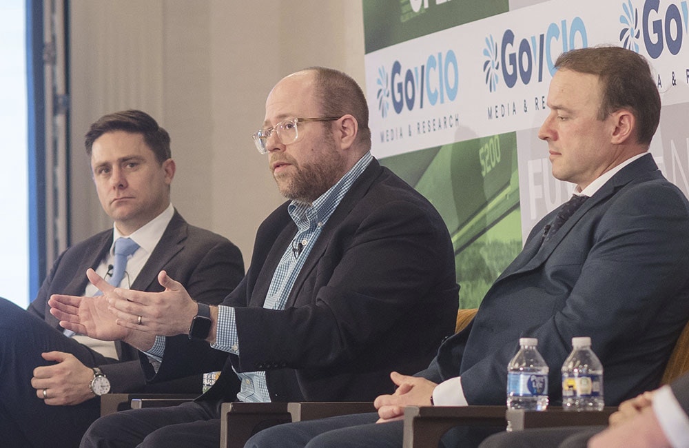 Jay Bonci, center, speaks at the Feb. 9 Defense IT Summit in Arlington, Virginia.