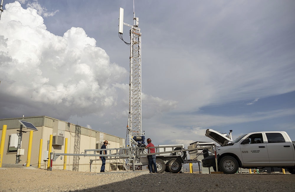 U.S. Marine Corps government employees with Headquarters Battalion, Marine Air Ground Task Force Training Command, Marine Corps Air Ground Combat Center (MCAGCC) raise a 5G tower in preparation for a 5G network demonstration at MCAGCC.