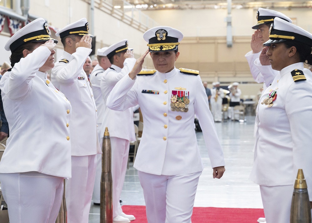 Rear Adm. Seiko Okano, commander, Naval Information Warfare Systems Command (NAVWAR), salutes the sideboys during the Tactical Networks Program Office (PMW 160) change of command ceremony, August 29, 2024.