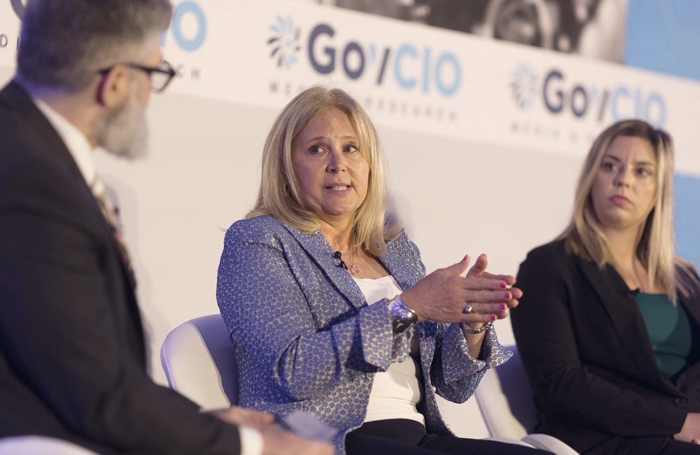 Defense Department's Principal Deputy CIO Leslie Beavers speaks during GovCIO Media & Research's 2025 Federal IT Efficiency Summit in Tysons Corner, Virginia, on July 10, 2025 as NNSA Acting Associate CIO and Director of Federal IT Program Management Kayla Gunter looks on.