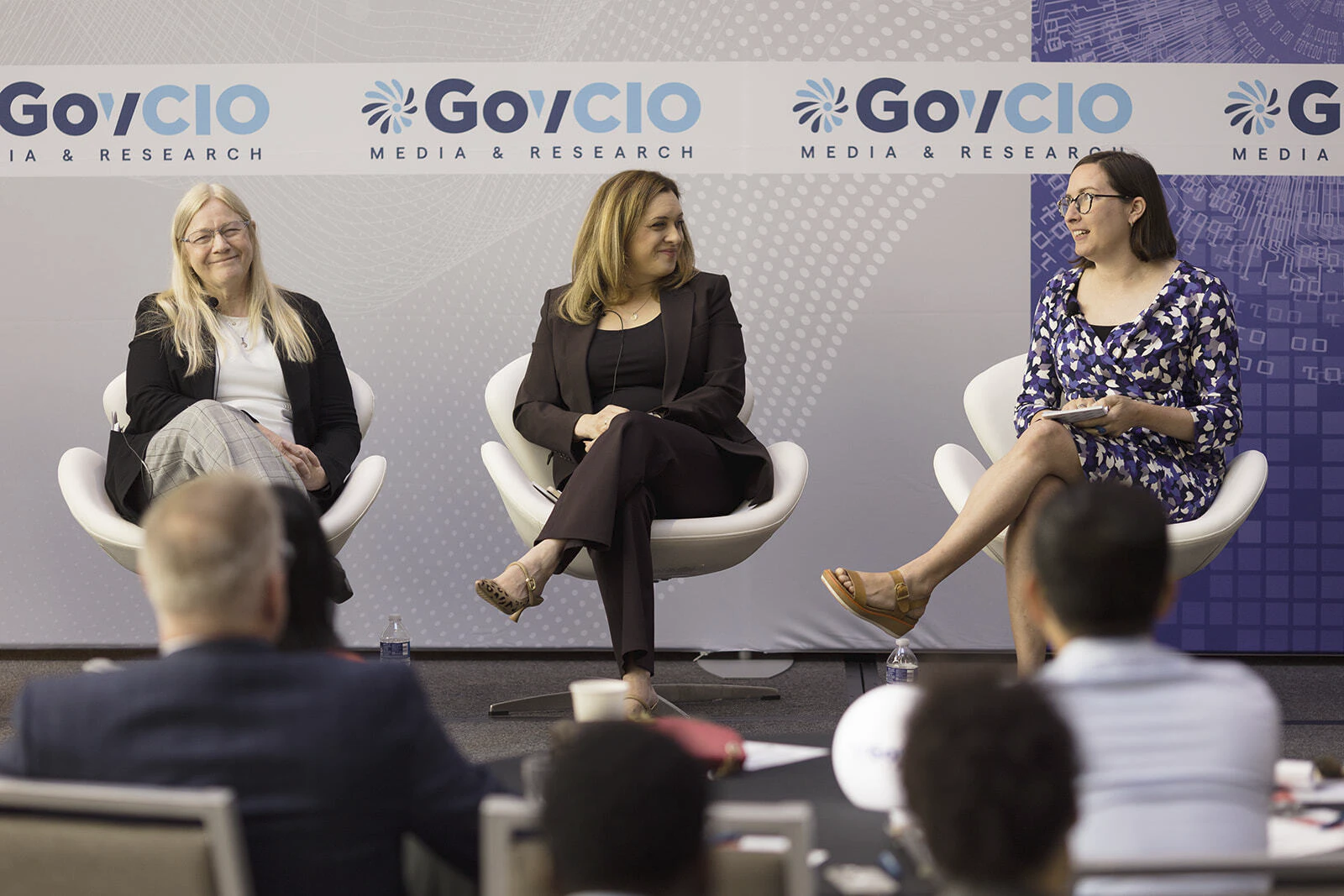 A group of presenters speak at the Federal Tech Leaders Summit