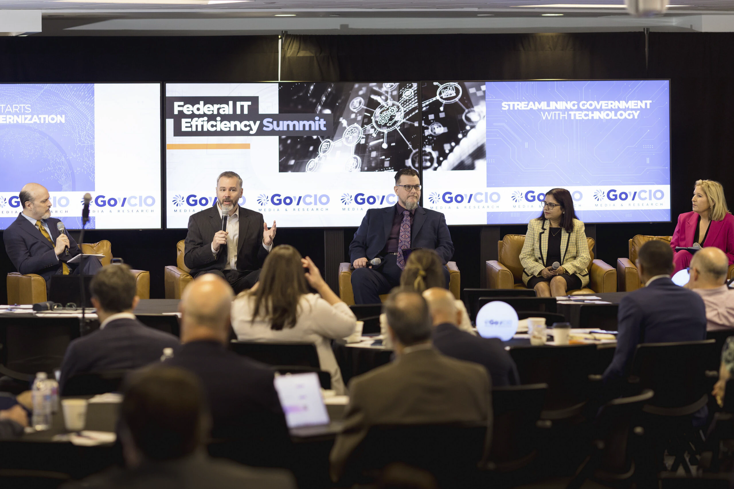 Photo of speakers at the 2026 Federal IT Efficiency Summit in Reston, VA