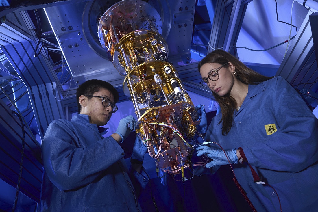 Two UConn researchers work on a quantum computer as a part of the UConn Quantum Alliance.