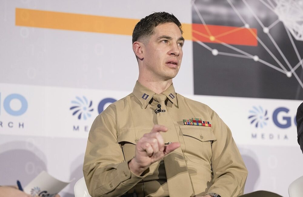 Capt. Christopher Clark, Marine Corps AI lead within the Service Data Office for the Deputy Commandant for Information, speaks at GovCIO Media & Research's AI Summit on Jan. 9, 2026, in Tysons, Virginia.