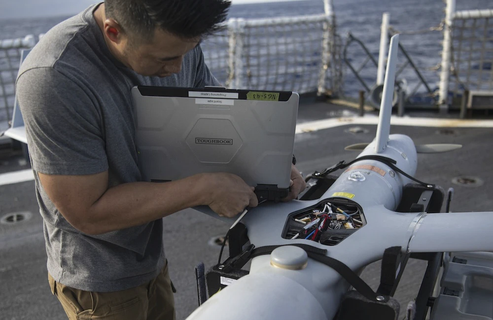 Darian Chan, a ScanEagle unmanned aerial system (UAS) team member aboard USCGC Hamilton (WMSL 753), prepares to launch a drone for a flight training exercise while underway in the Atlantic Ocean, Oct. 17, 2022.