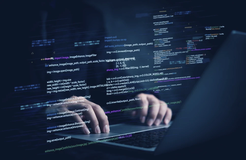 Hands typing on laptop with programming code on screen, representing software development. Perfect for coding, IT solutions, digital technology, web applications.