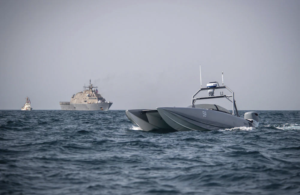 A Devil Ray T-38 unmanned surface vessel, littoral combat ship USS Sioux City (LCS 11 and U.S. Coast Guard cutter USCGC Baranof (WPB 1318) sail in the Arabian Gulf in 2002.