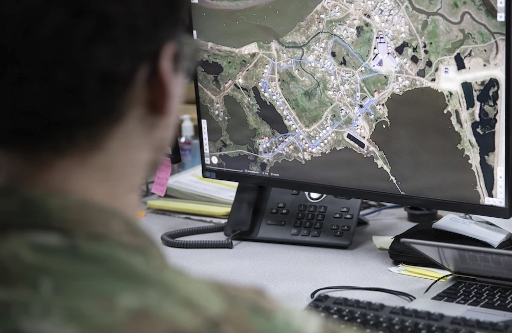 Tech. Sgt. Wolf Russo, common operating picture manager with the Alaska National Guard’s Joint Force Headquarters, demonstrates capabilities of Maven in response to Western Alaska storms at Joint Base-Elmendorf in Richardson, Alaska. Nov. 10, 2025.