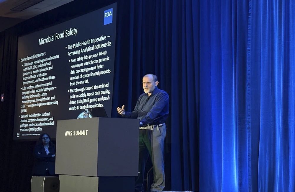 Man speaks on a stage at AWS Summit