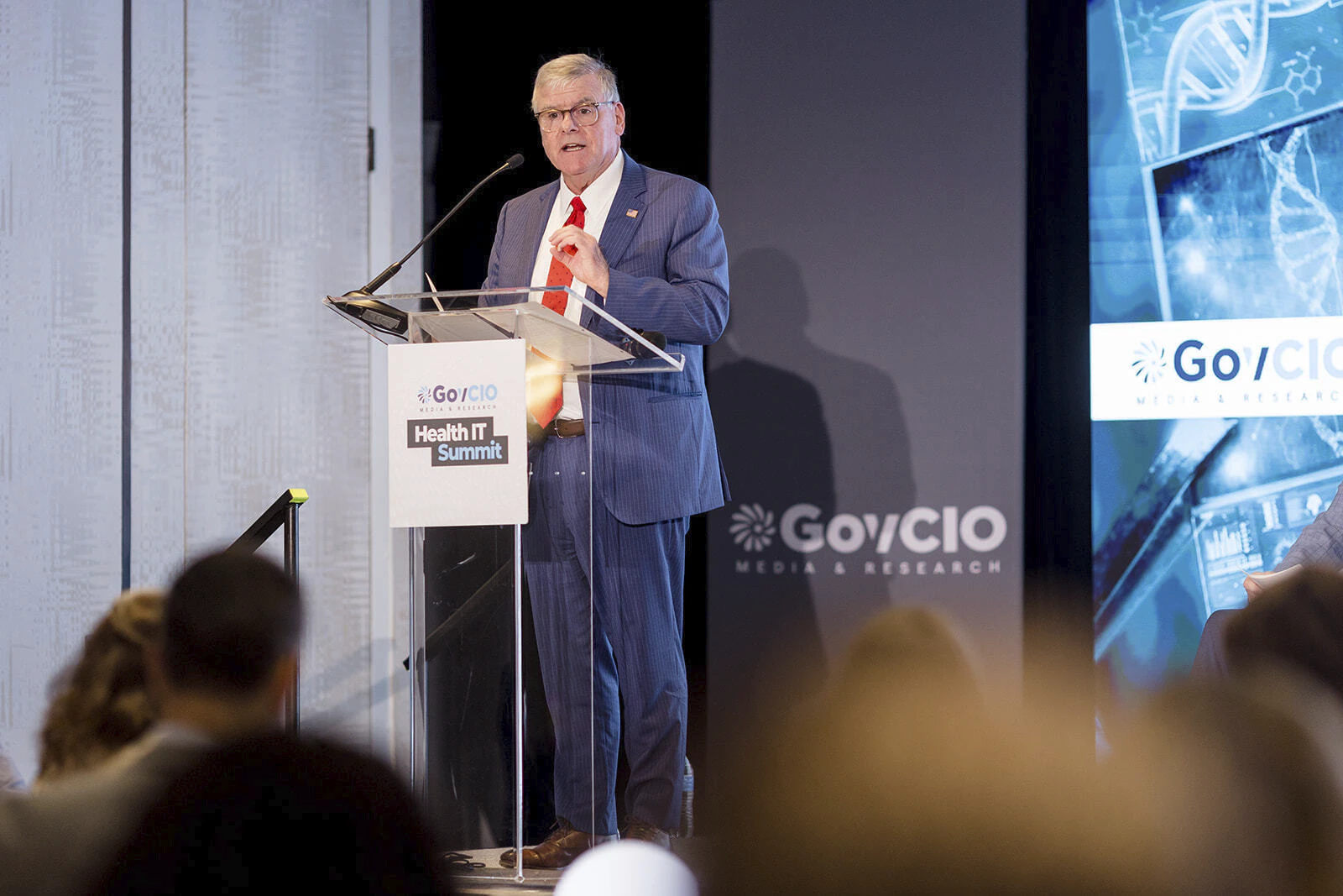 Tom Engles speaking at the podium at Health IT Summit 2026